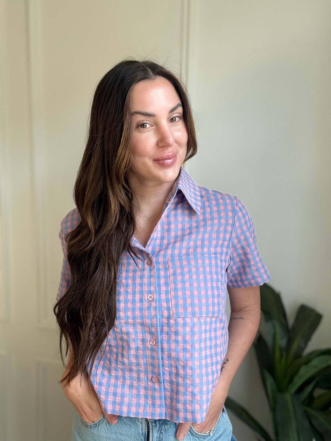 Woman wearing a blue and pink checkered Check-In Tie Back Top, showcasing a relaxed fit and modern style.