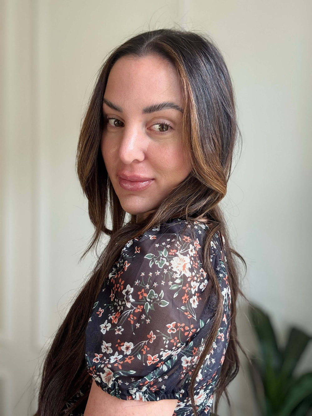 Model wearing a Floral Breeze Bodysuit with a vibrant floral pattern, showcasing style and comfort.