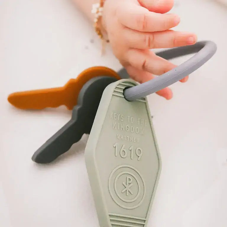 Silicone baby teether in key shape, symbolizing faith and love, inspired by Matthew 16:19. Perfect for soothing teething babies.