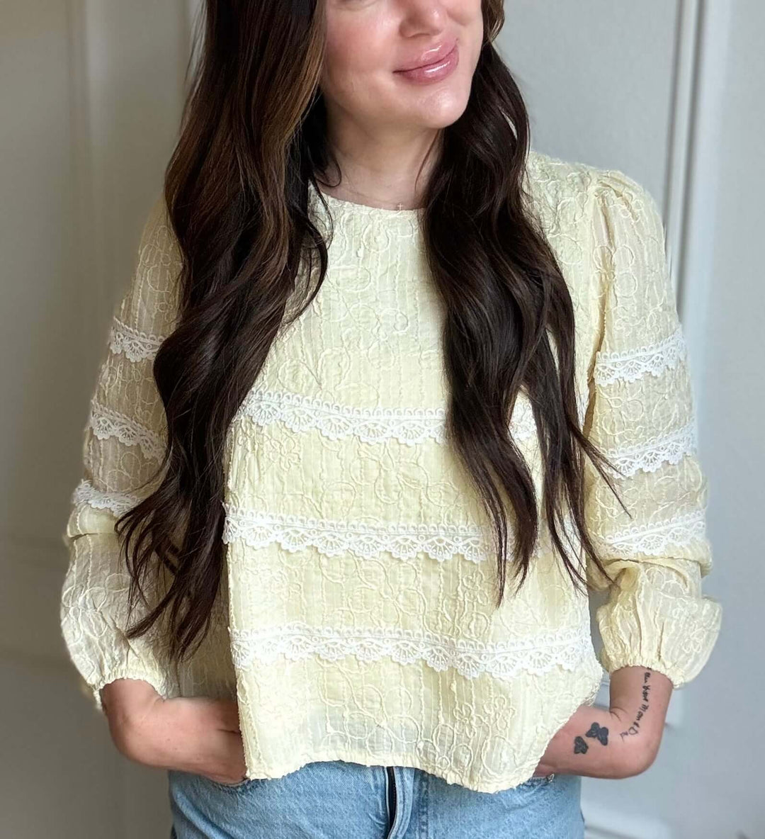 Luminous blouse for women, showcasing intricate lace details in soft yellow fabric, radiating elegance and comfort.