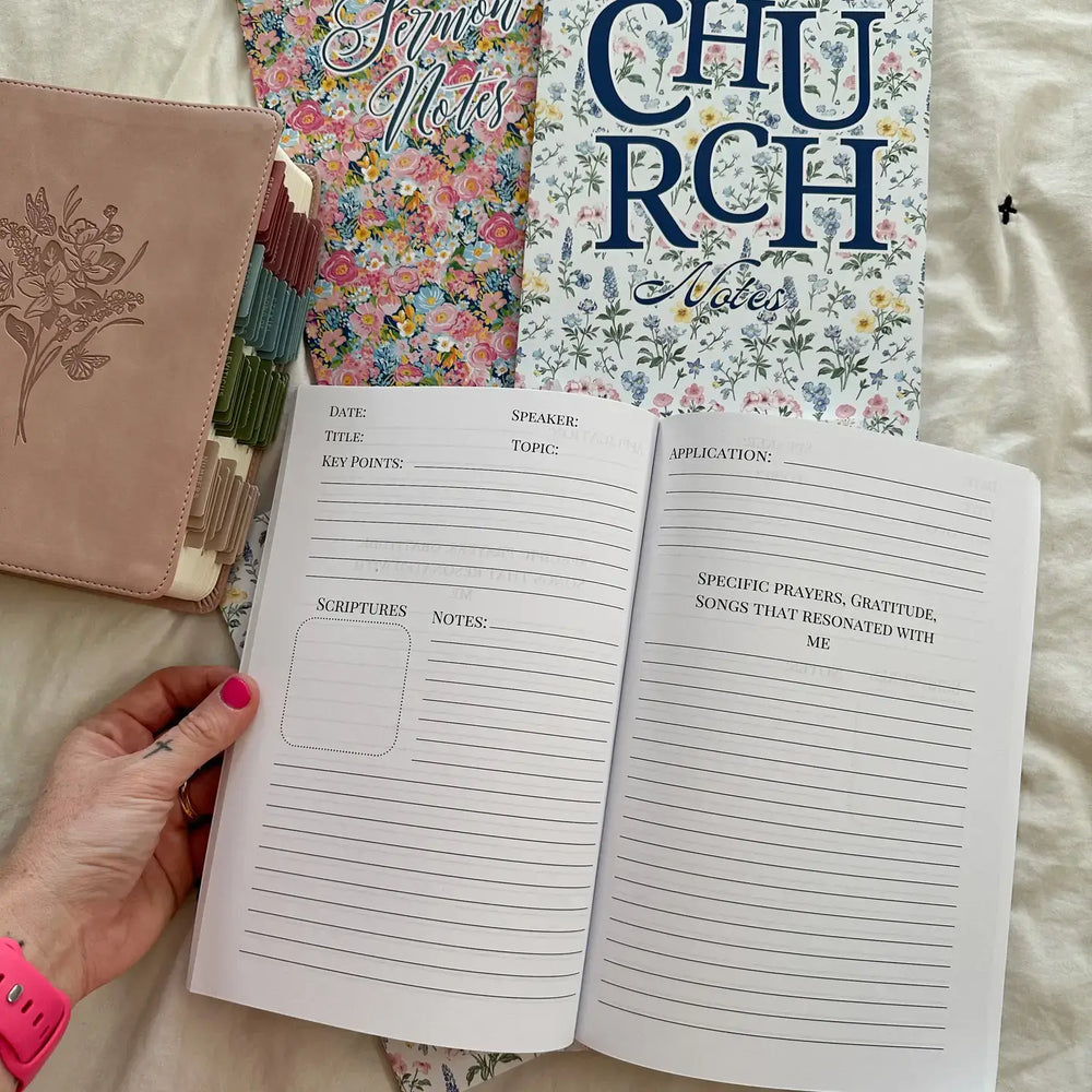 Hand holding open Serenity Notes Journal with floral covers for capturing spiritual reflections and notes.