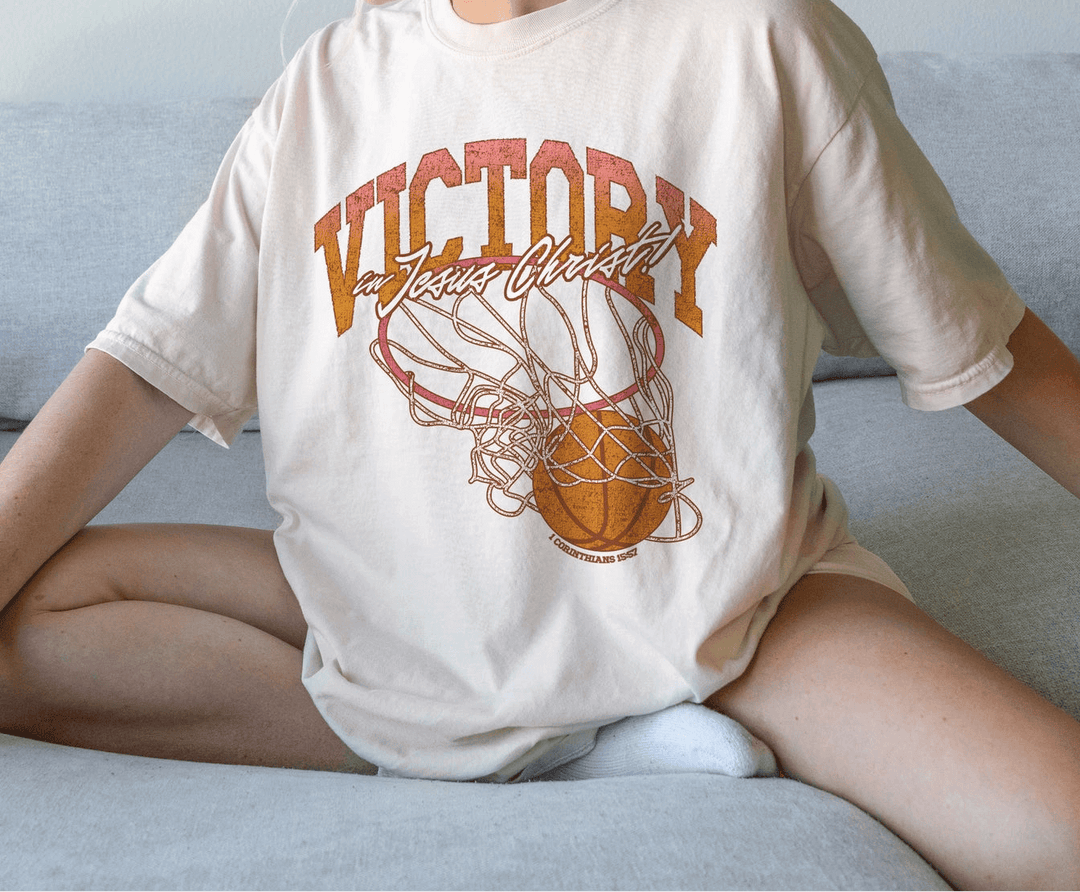 Victory in JC Tee featuring a graphic design of a basketball, showcasing casual style and comfort.