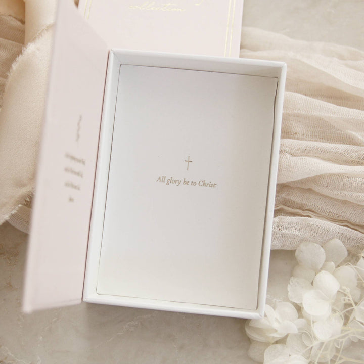 Inside view of jewelry box with 'All glory be to Christ' engraving and a cross design.