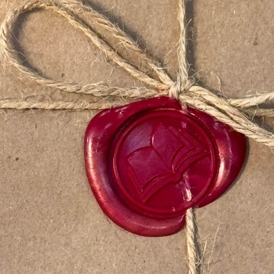 Close-up of a red wax seal with a book image on a wrapped parcel for a blind date with a book.