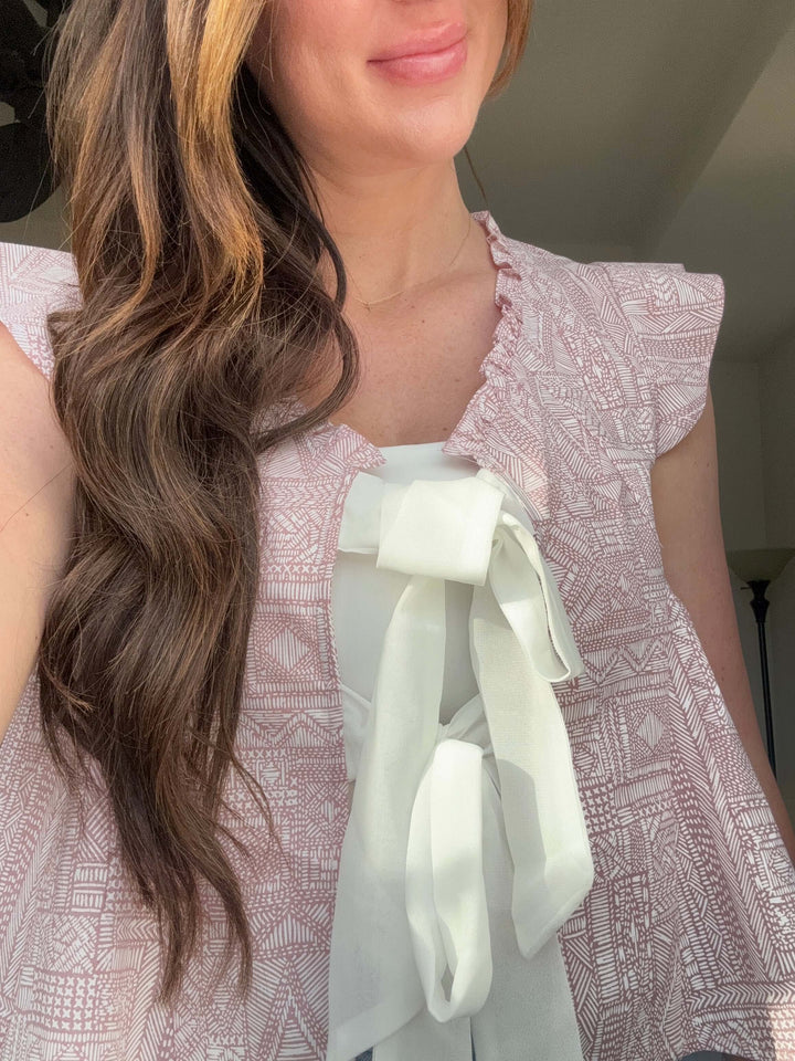 Model wearing Bohemian Grace Ruffle Tie-Front Blouse in mauve with ruffled shoulders and tie detail.