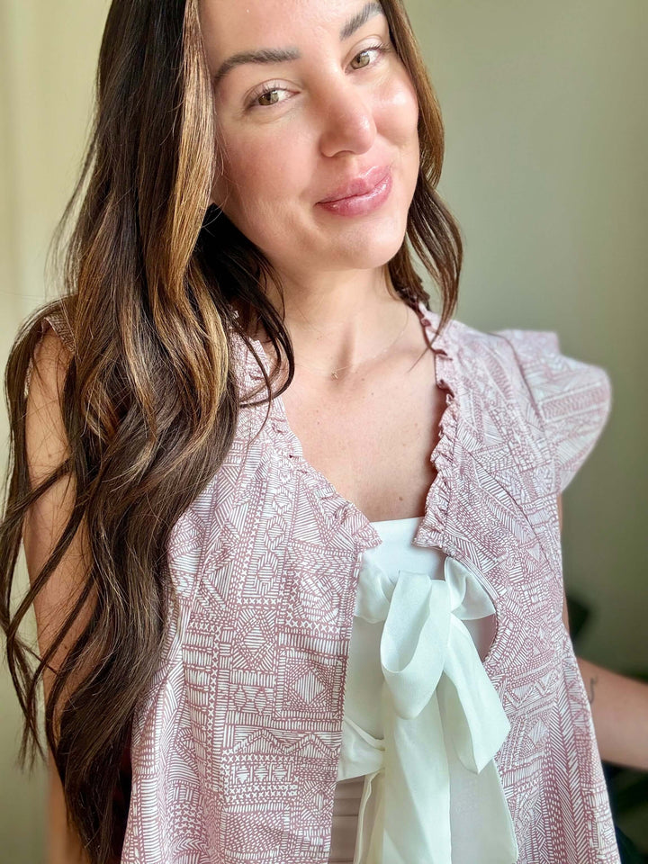 Woman wearing Bohemian Grace Ruffle Tie-Front Blouse in mauve with ruffled shoulders and tie detail.