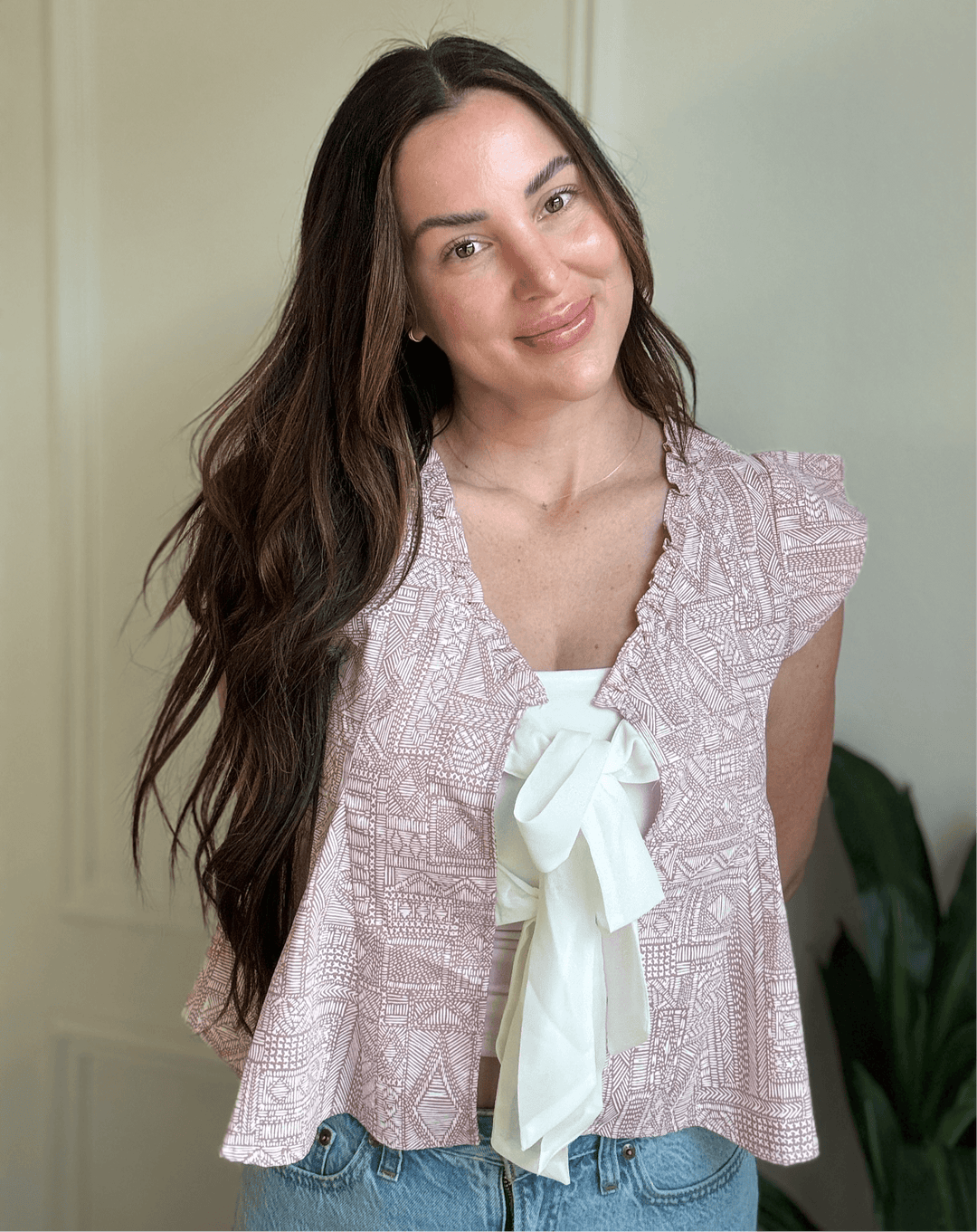 Woman wearing Bohemian Grace Ruffle Tie-Front Blouse in mauve with ruffled shoulders and a tie detail.