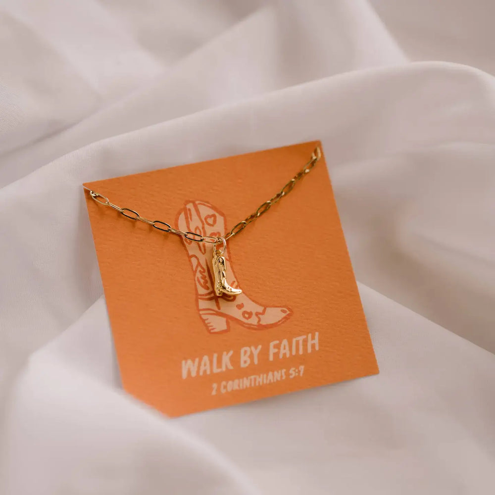 Boot Charm Necklace on display card, inspired by 2 Corinthians 5:7, symbolizing faith and style.