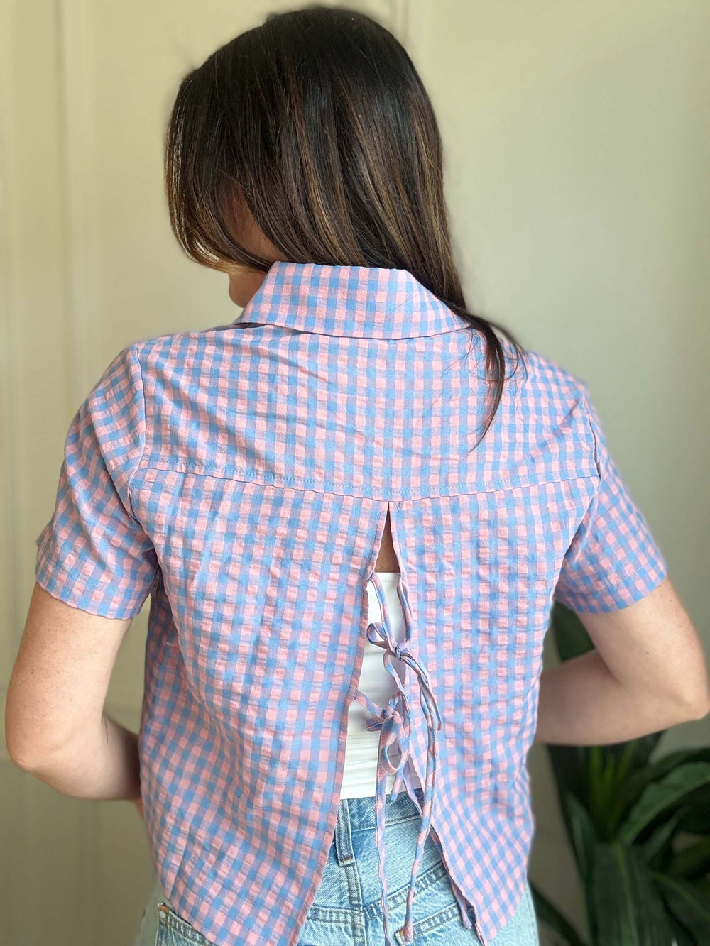Check-In Tie-Back Top featuring a pink and blue checkered pattern with a unique tie-back design.