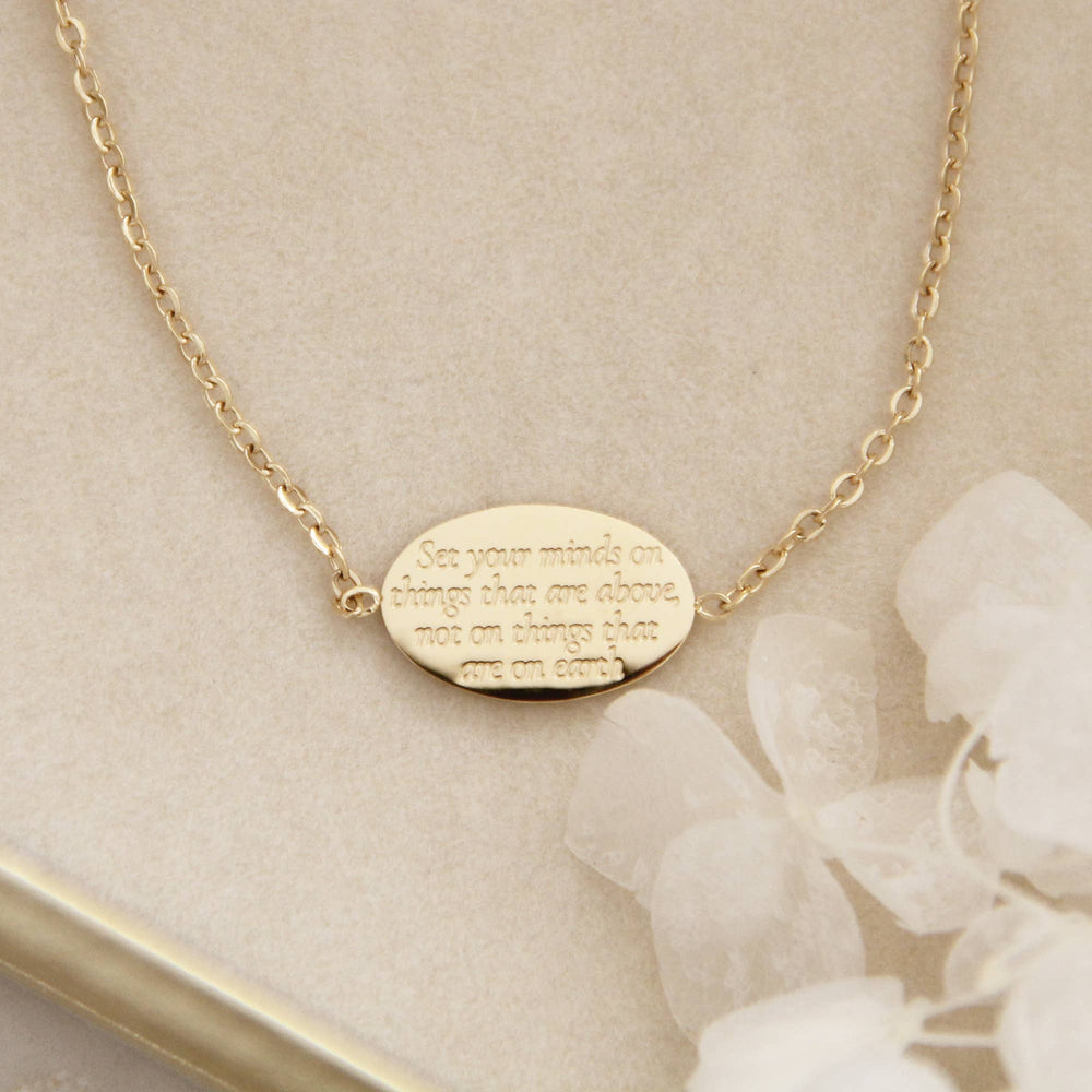 Colossians 3:2 bracelet featuring engraved message encouraging a heavenly perspective, elegant gold design.