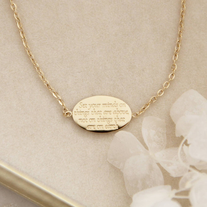 Colossians 3:2 bracelet featuring engraved message encouraging a heavenly perspective, elegant gold design.