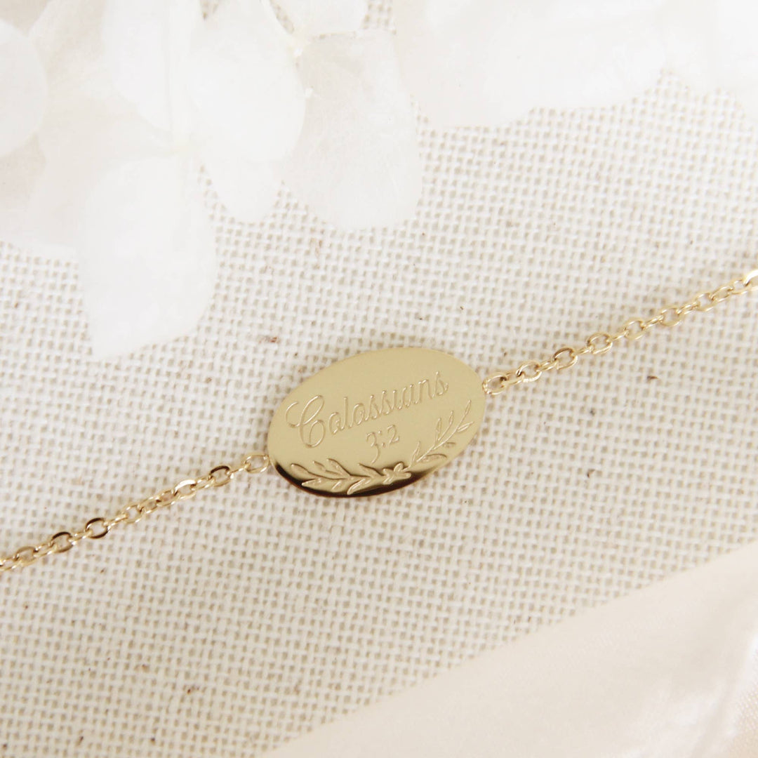 Close-up of the gold Colossians 3:2 engraved bracelet, symbolizing faith and inspiration.