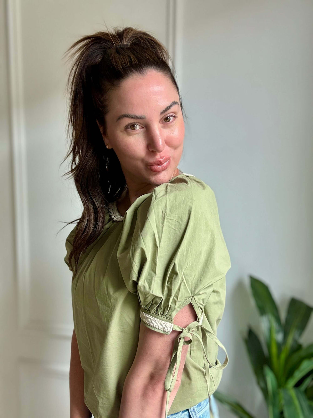 Elegant olive blouse with lace trim, perfect for Christian women's fashion, featuring puff sleeves and a feminine silhouette.