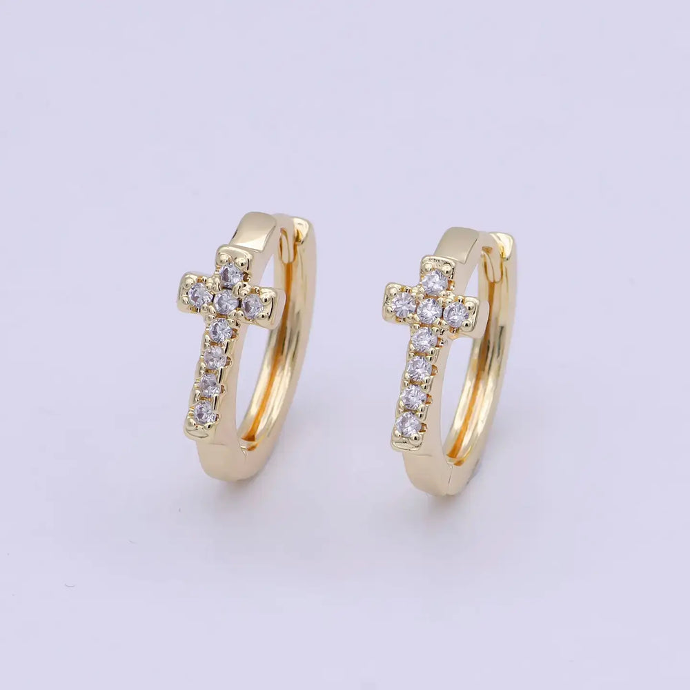 Eternal Grace Huggie Earrings with gold cross design and sparkling stones, symbolizing faith and elegance.