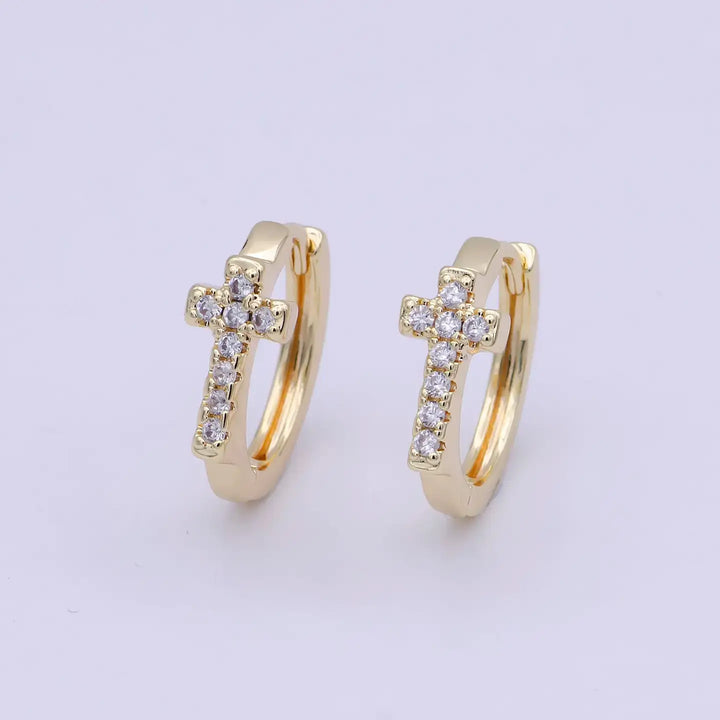 Eternal Grace Huggie Earrings with gold cross design and sparkling stones, symbolizing faith and elegance.