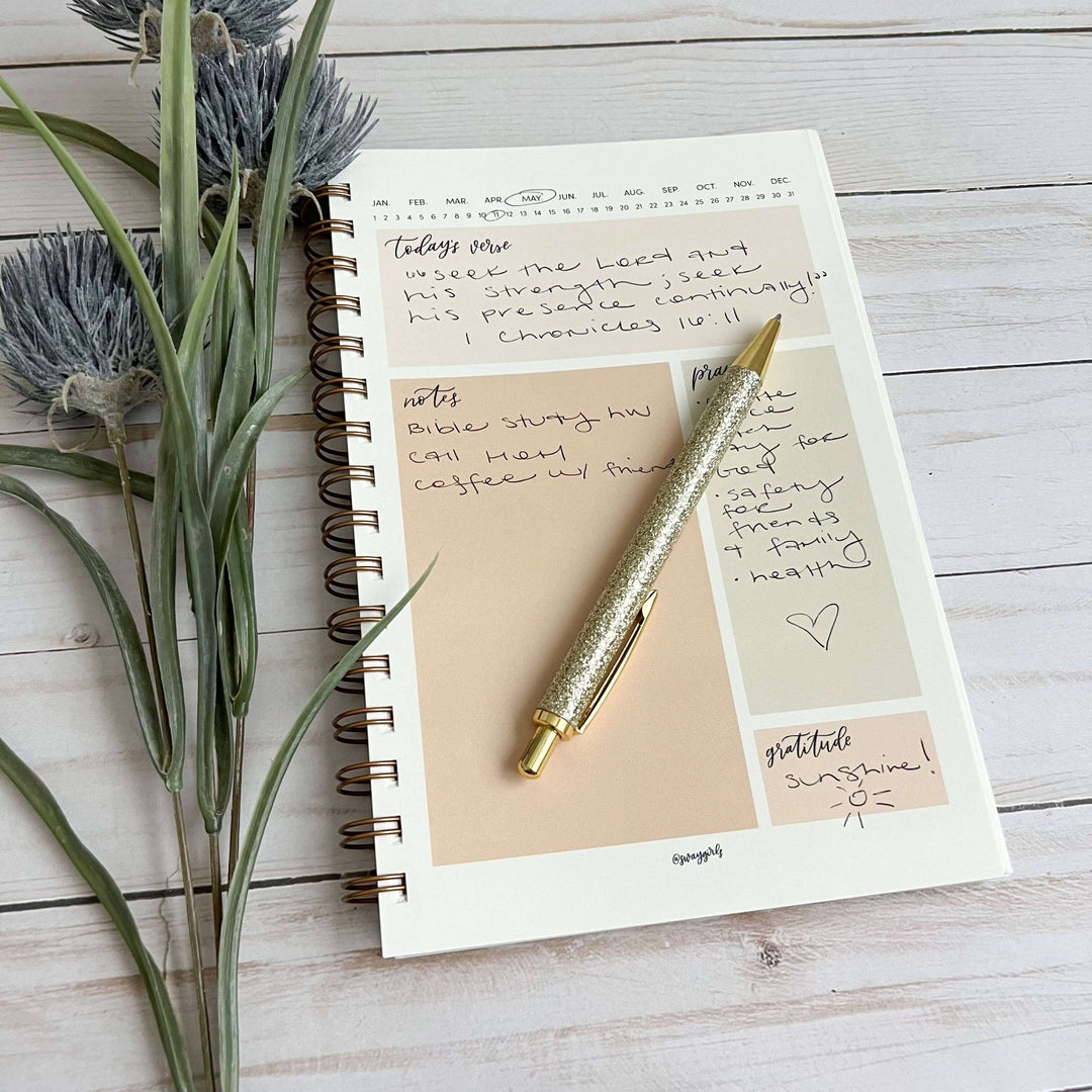 Heaven and Earth Bible Study Notebook open with notes and a gold pen, perfect for Christian women and spiritual growth.
