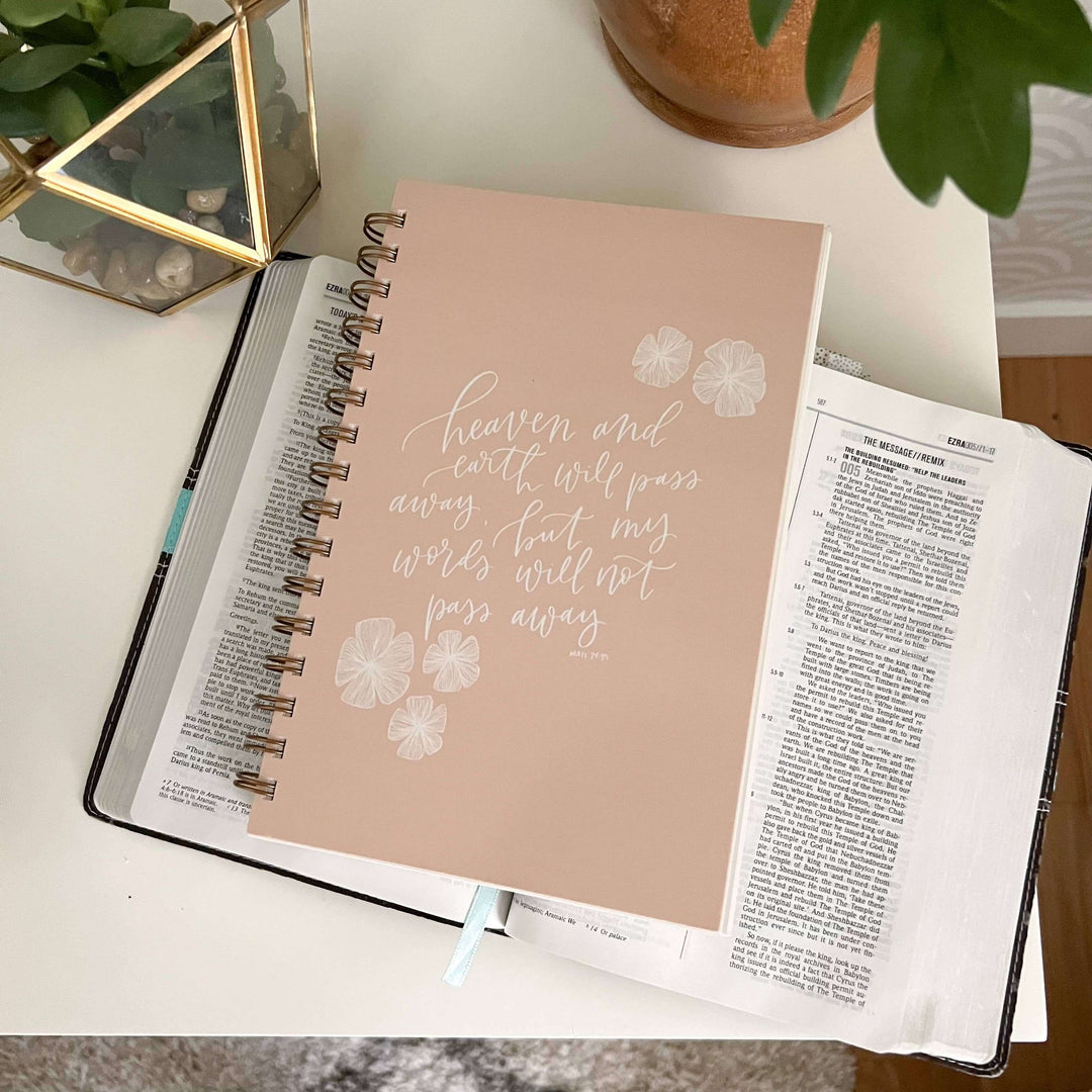 Heaven and Earth Bible Study Notebook on an open Bible, designed for Christian women and spiritual growth.