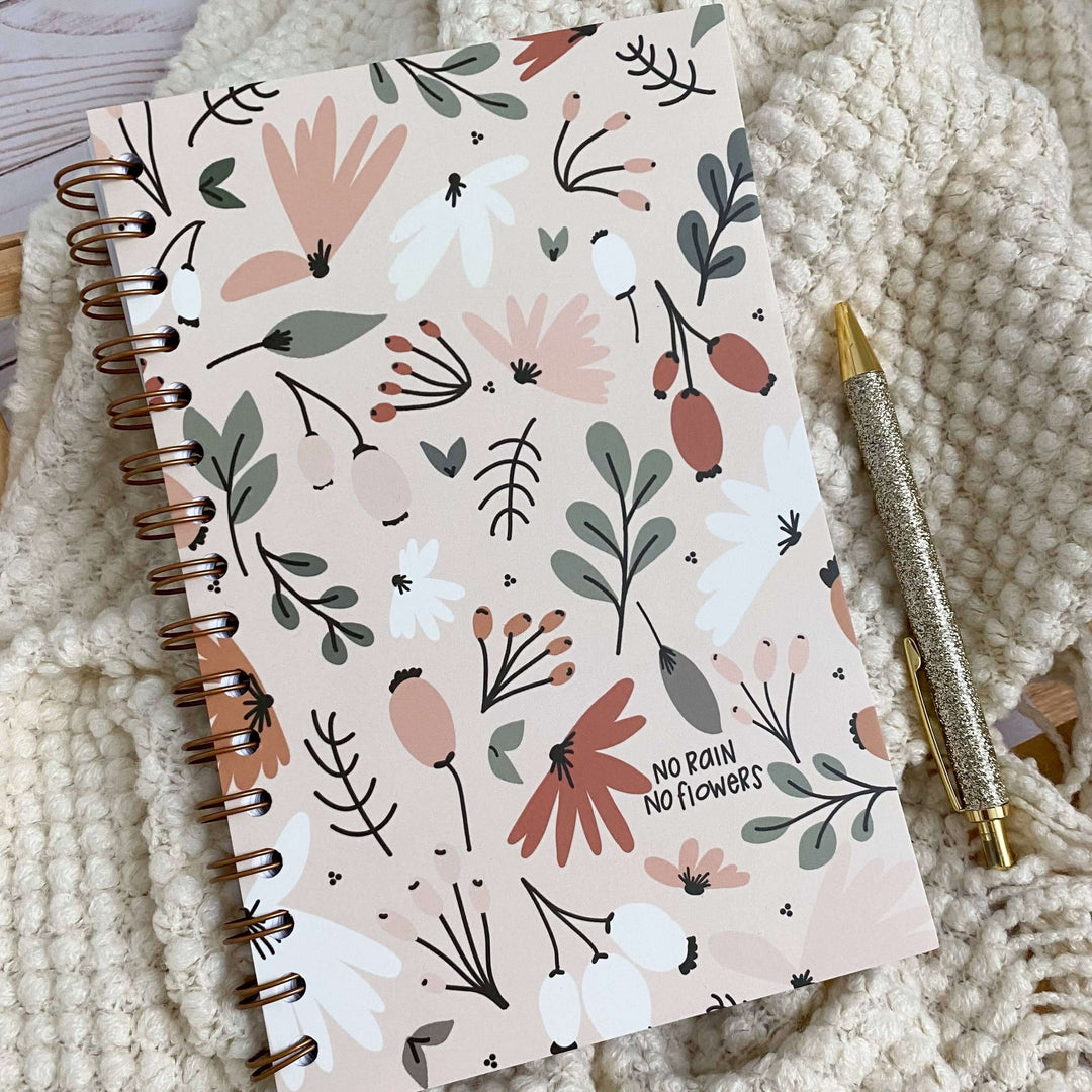 Spiral-bound No Rain No Flowers notebook with floral design, perfect for Christian women journaling and devotionals.