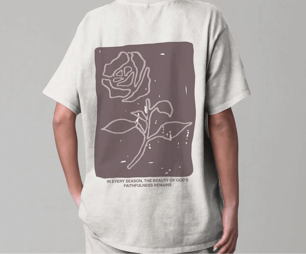 Back view of Faithfulness Tee featuring a rose design and inspirational quote on lightweight heavyweight cotton.