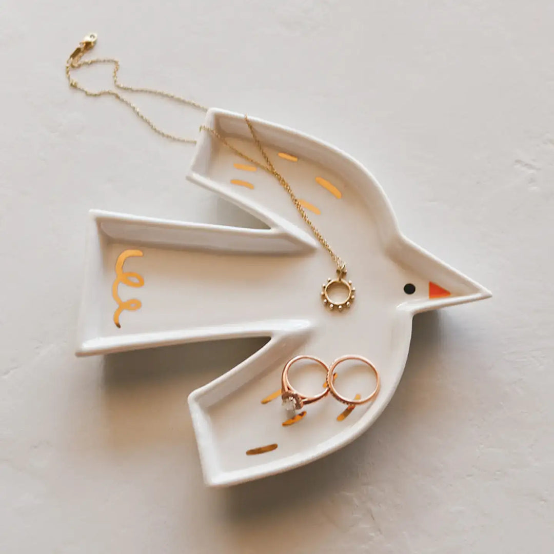 Holy Spirit trinket dish shaped like a dove, holding jewelry, with gold accents and fine porcelain finish.
