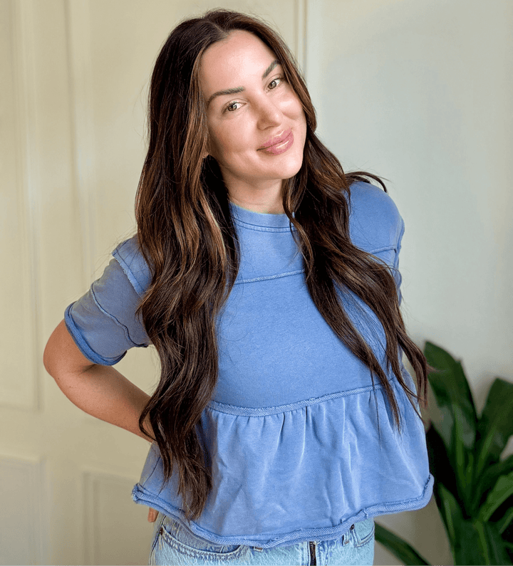 Joyous Tiered Blouse in soft denim blue, featuring cascading ruffles for a feminine silhouette, perfect for Christian women's fashion.