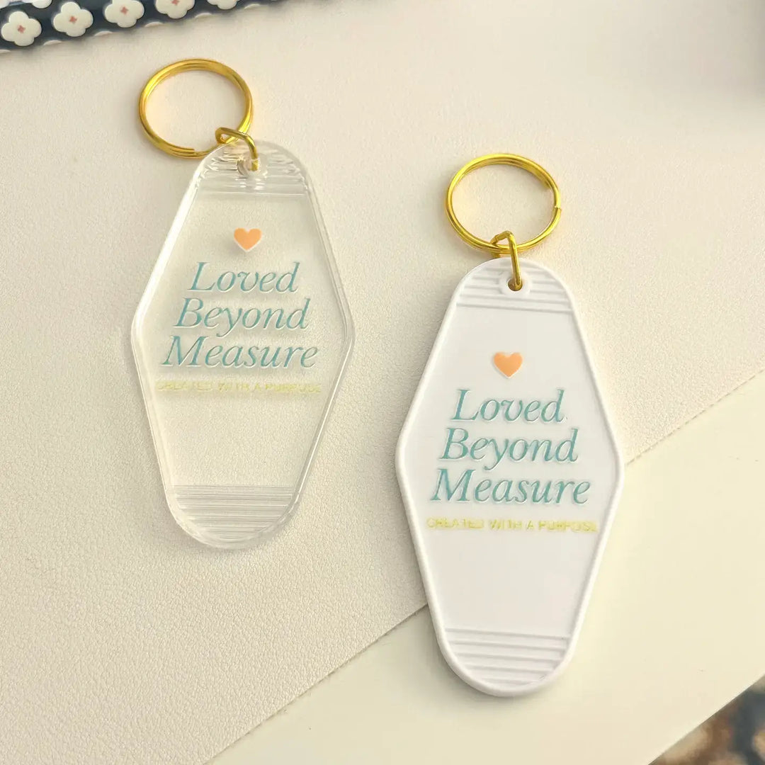Acrylic keychain with 'Loved Beyond Measure' design, featuring gold keyring, perfect for keys and accessories.