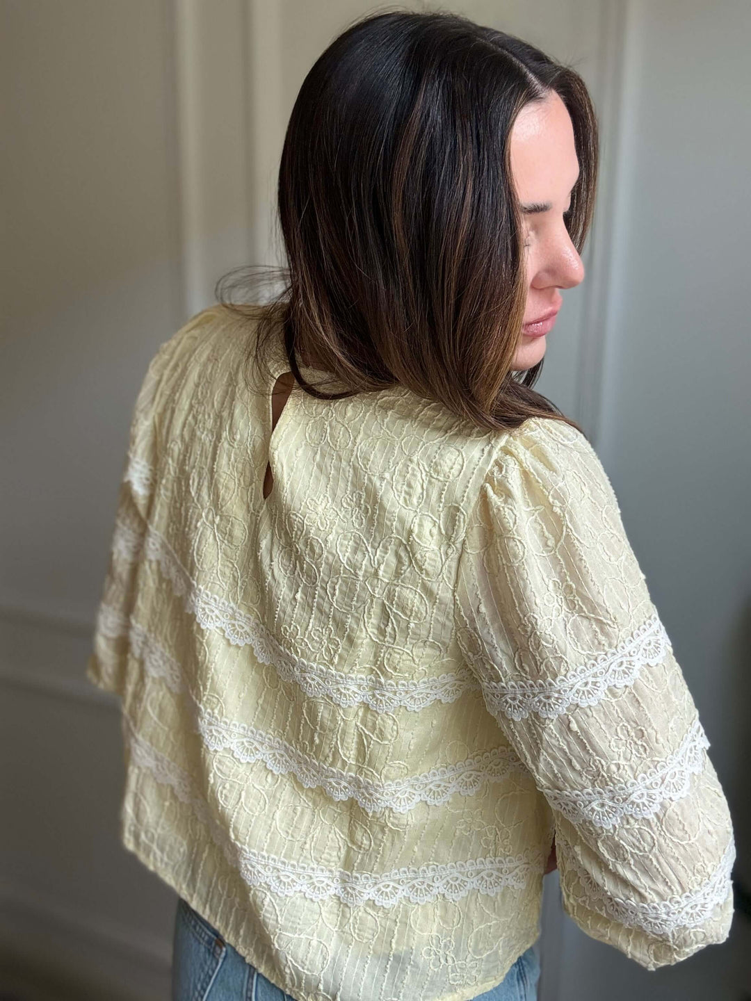 Luminous blouse showcasing intricate lace and floral design, perfect for elegant Christian women's fashion.