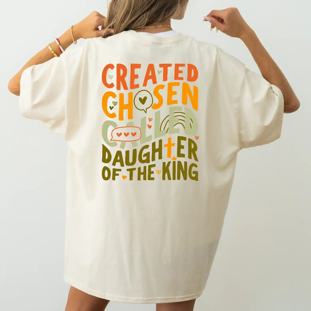 Back view of Called Oversized Tee featuring 'Created, Chosen, Daughter of the King' design in vibrant colors.