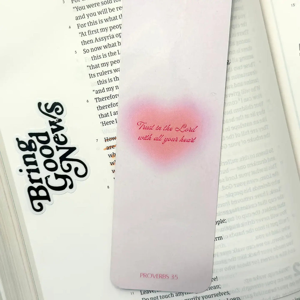 Proverbs bookmark featuring the verse "Trust in the Lord with all your heart" beside an open Bible.