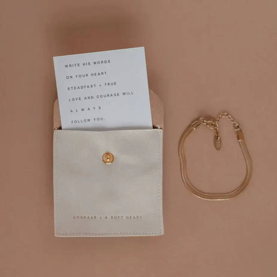 Steadfast Love Bracelet with inspirational card in a cream pouch, promoting faith, love, and courage.