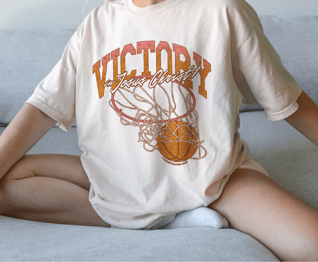Victory in JC Tee featuring a graphic design of a basketball, showcasing casual style and comfort.
