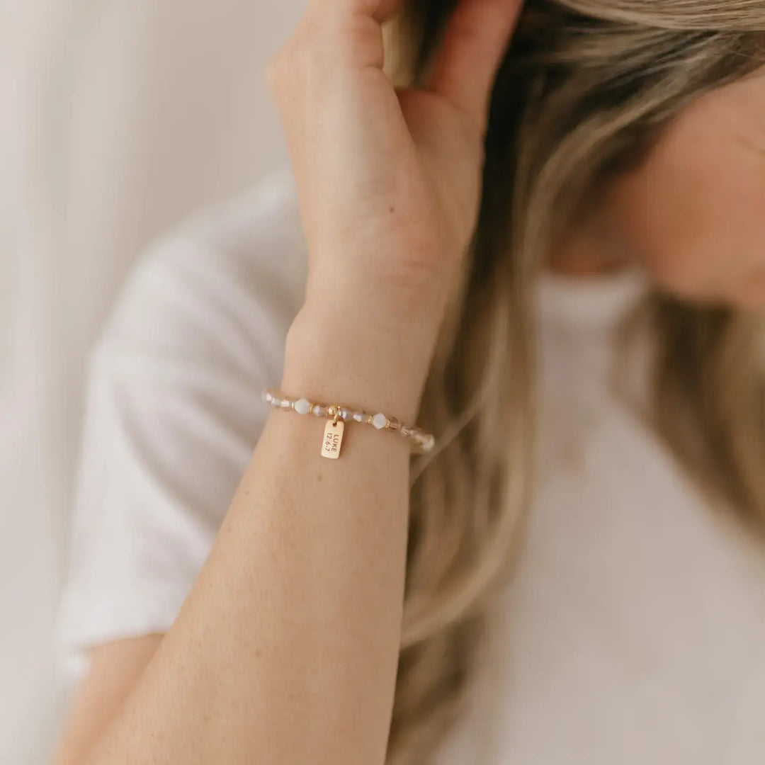 Worthy Beaded Stretch Bracelet worn on a woman's wrist, symbolizing value and faith in God.